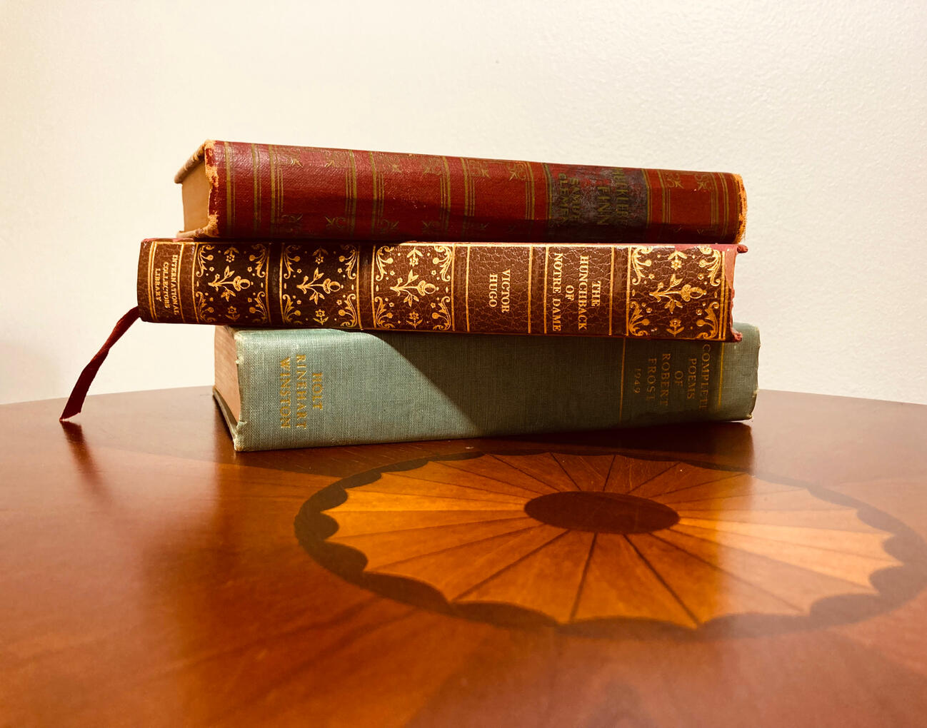 Three Books Stacked on a Round Table