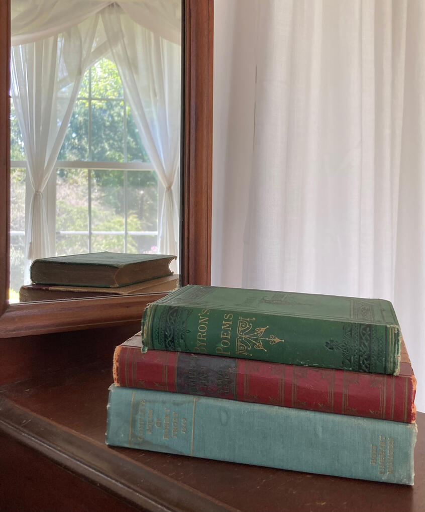 Three Books Stacked on a Vanity Table