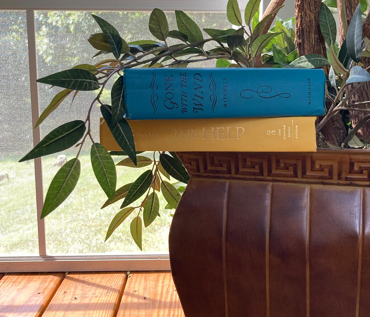 Two Books Sitting on the Edge of a Planter